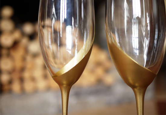 an easy diy tutorial for gold dipped votive wine glasses that would be perfect glassware for the new couple